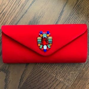 Brand new! Red velvet clutch with stone detail.